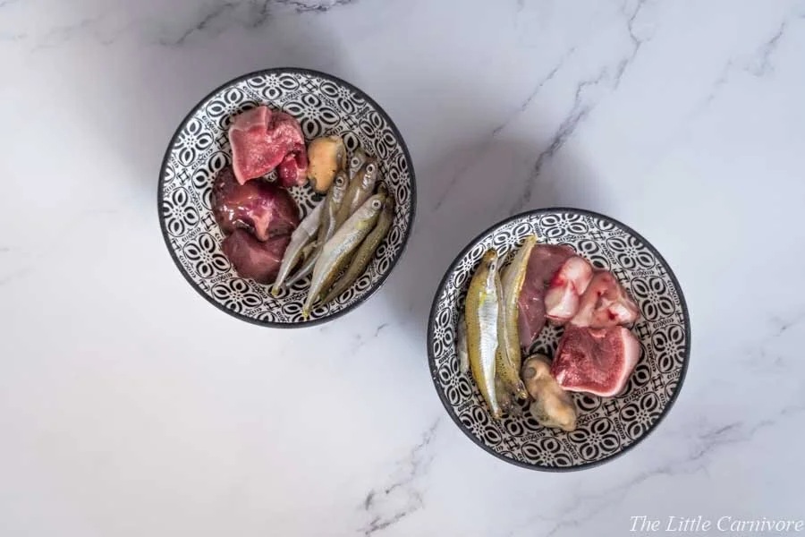 Raw meat and supplements on a cutting board